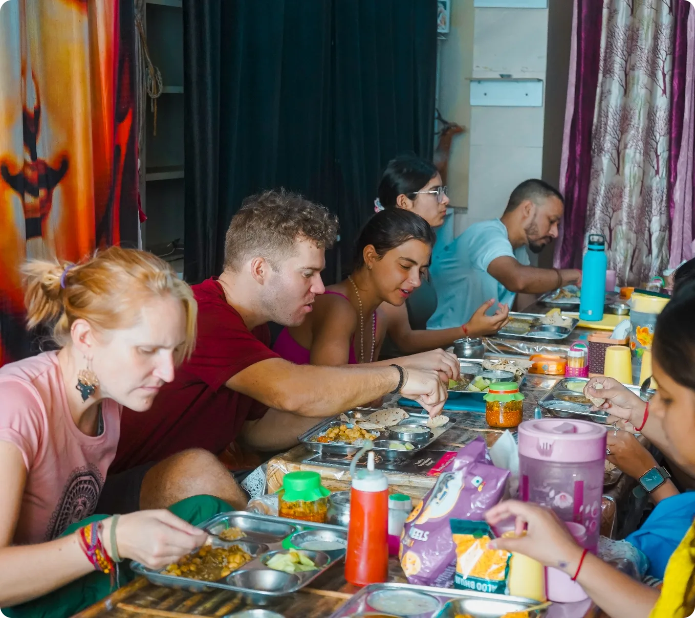 Yoga teacher training students sharing a sattvic vegetarian meal together at Rishikesh Yog Nirvana